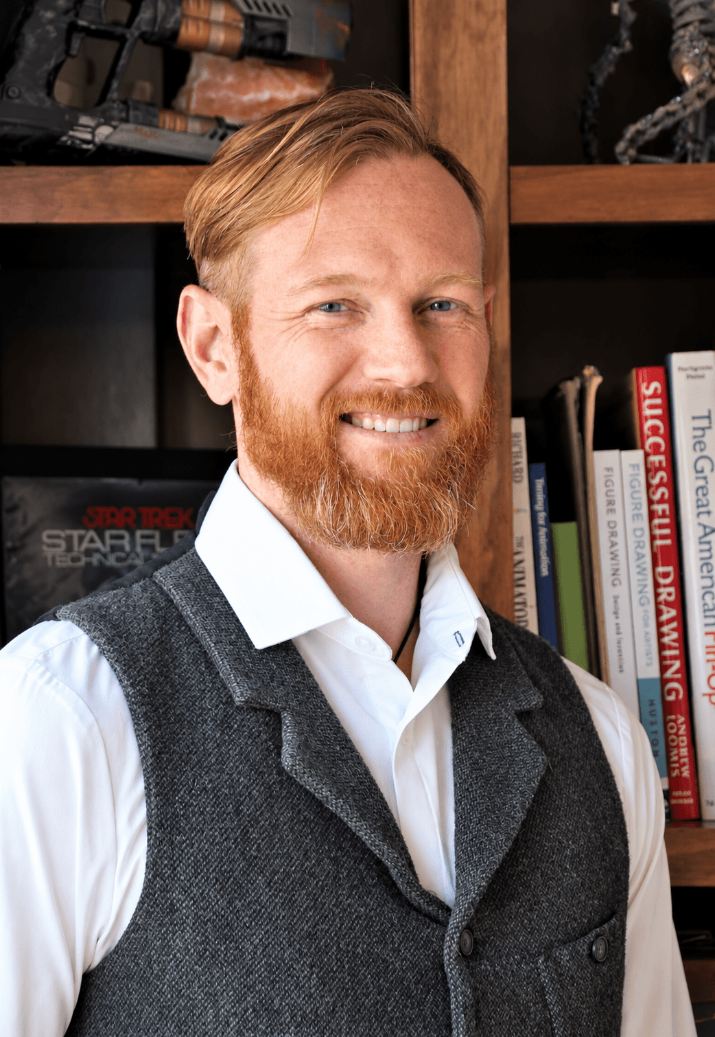 Portrait of Brent Golembiewski in front of a bookshelf.